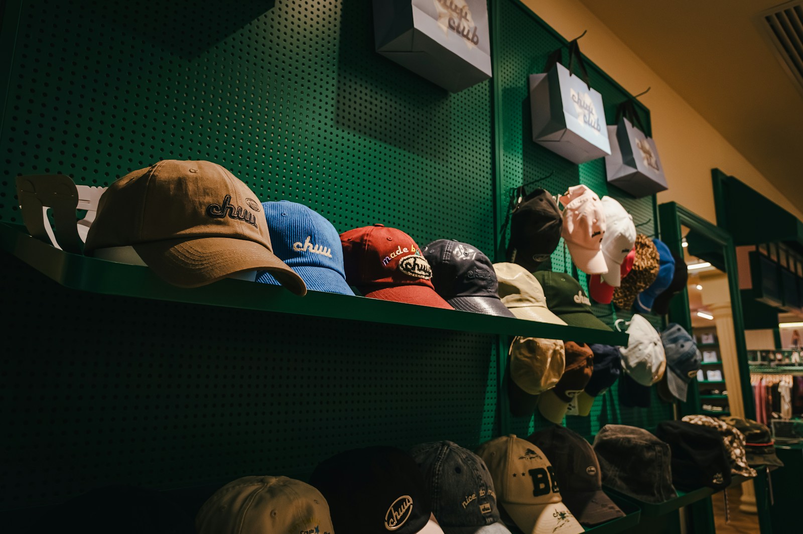 Hats are displayed on shelves in a store.