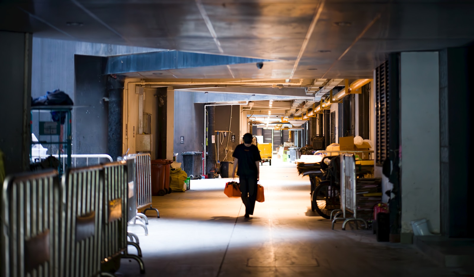 A person walking down a hallway with luggage