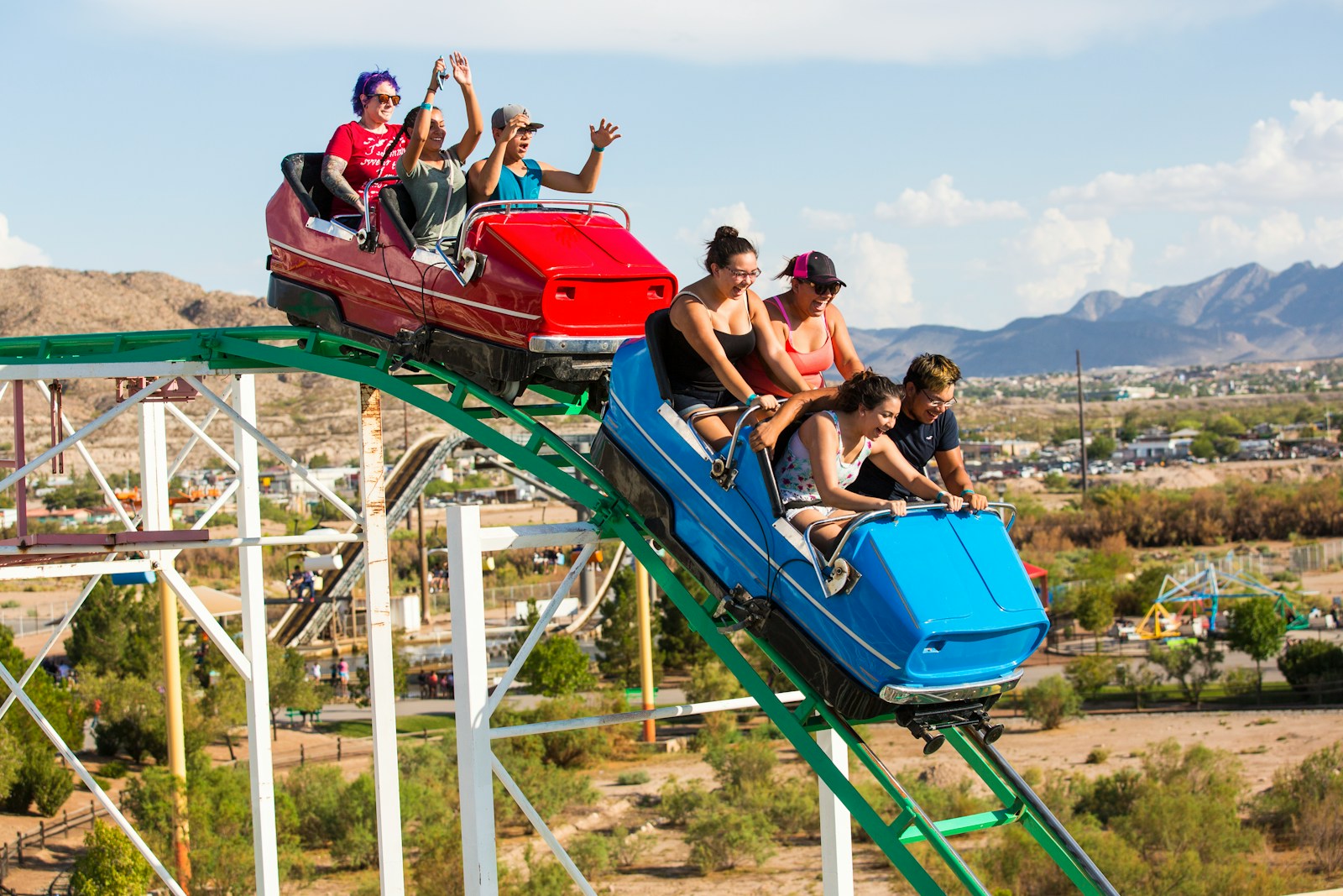 2 women sitting on blue hammock during daytime