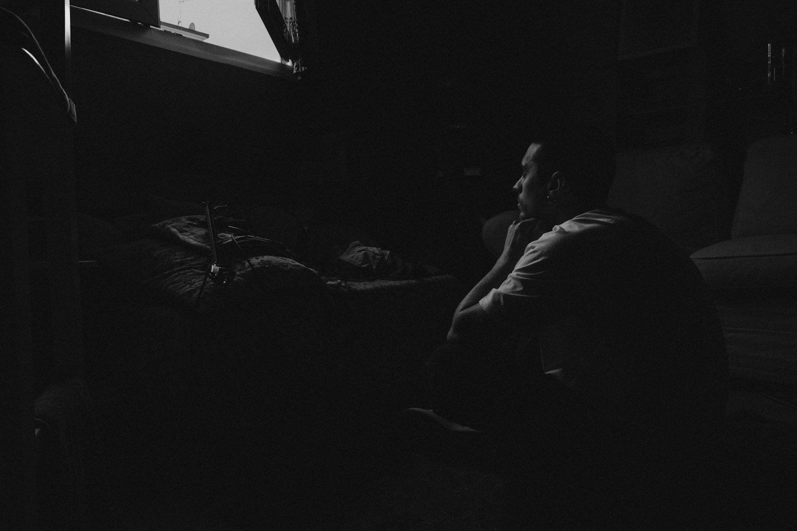 a person sitting in a dark room