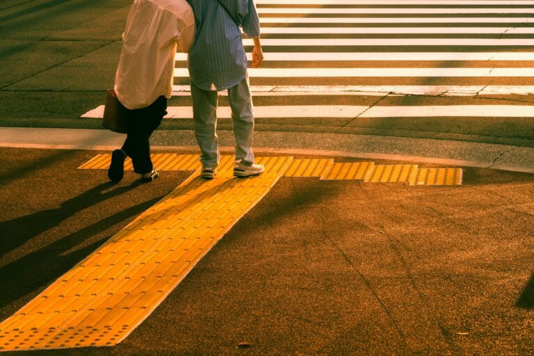 a couple of people walking across a cross walk