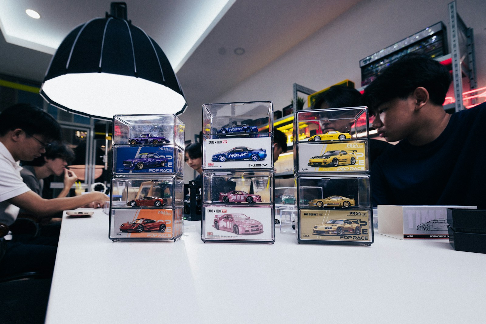 People at a counter with display cases