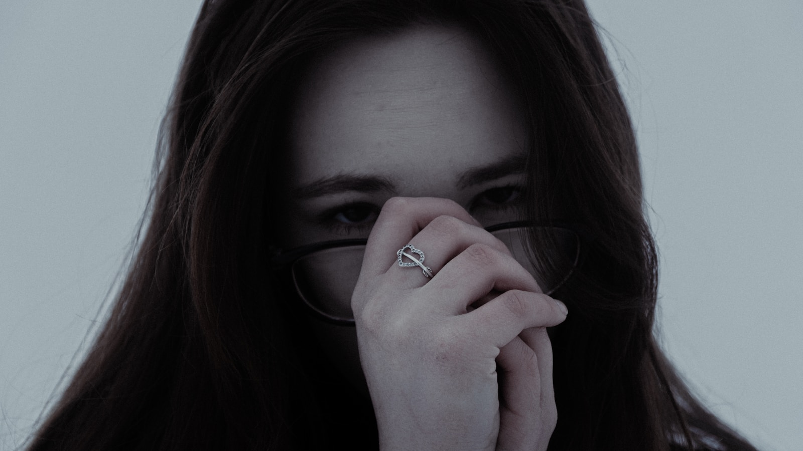 Young woman wearing glasses and a ring