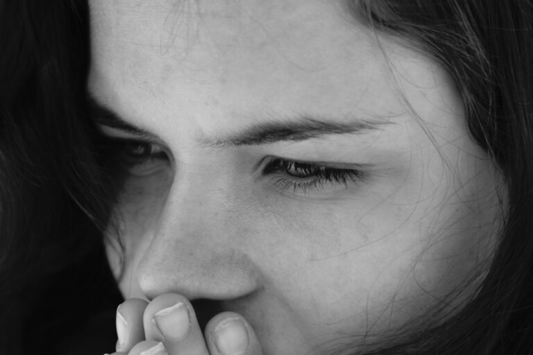 A woman holding her hand to her mouth
