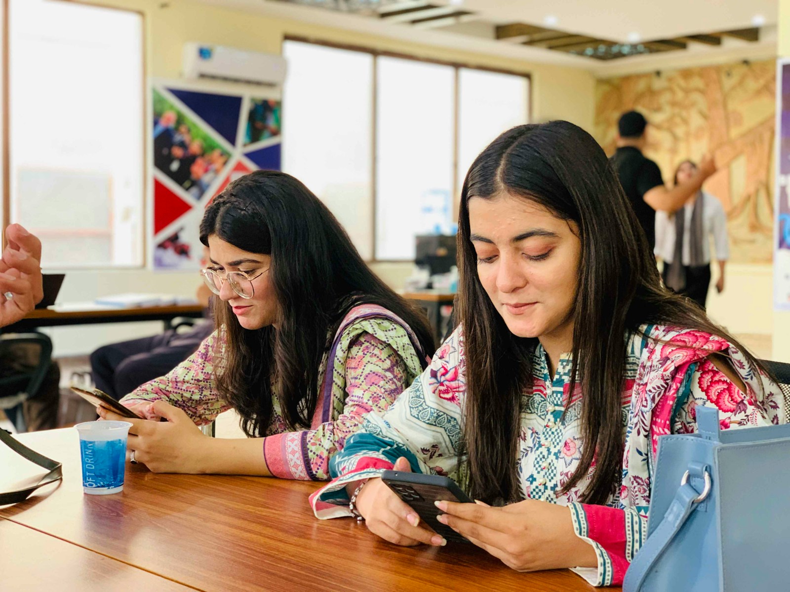 Two young women looking at their phones