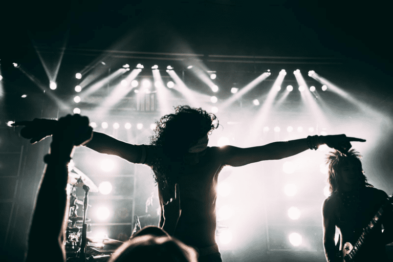 Energetic rock band performance with striking stage lights and silhouettes.