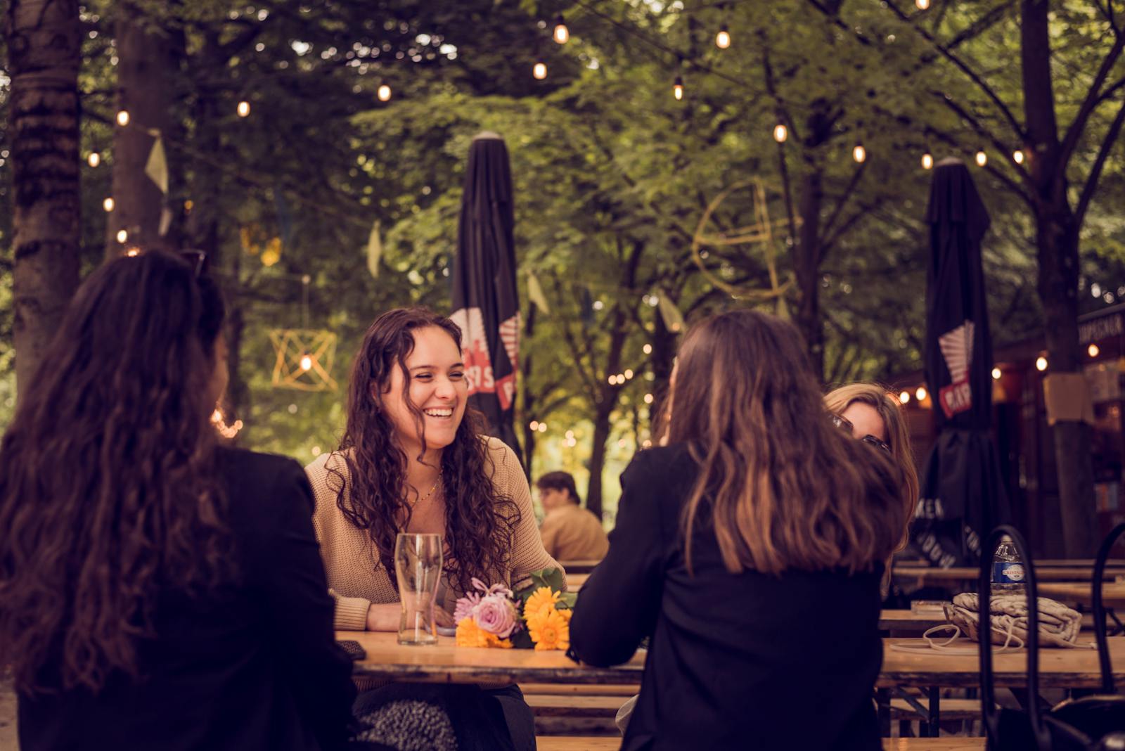Group of women enjoying conversation at an outdoor cafe in Brussels.