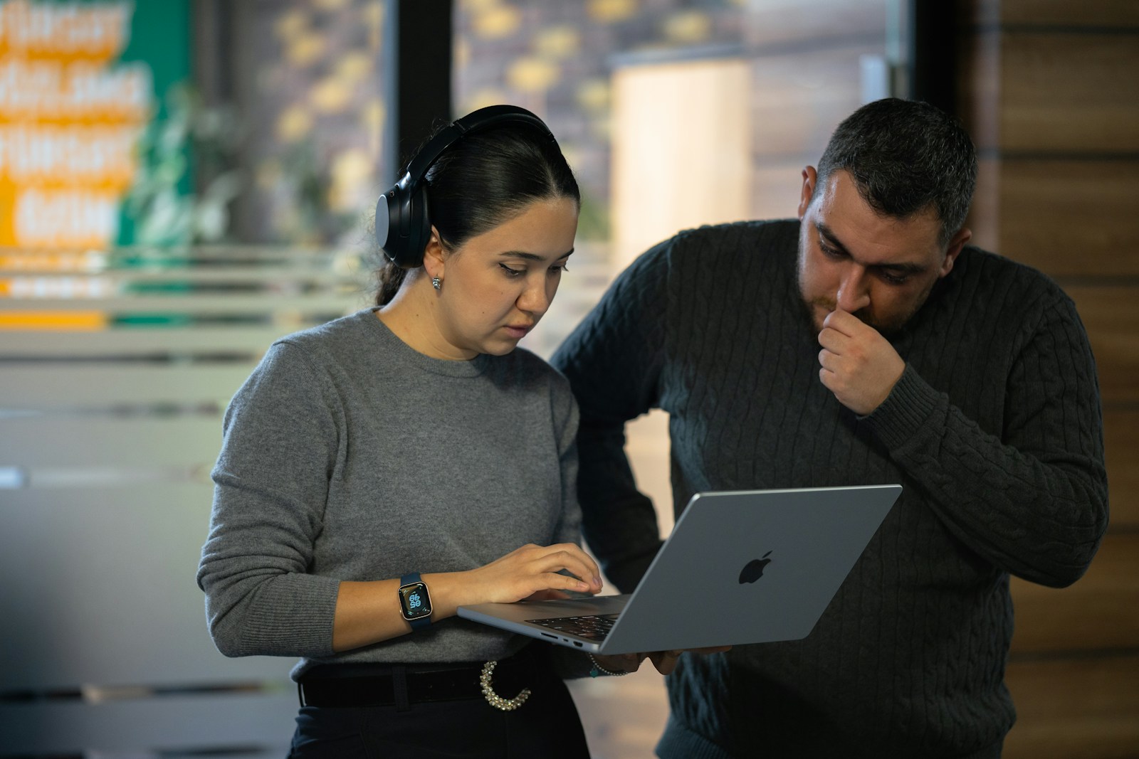 A man and a woman looking at a laptop