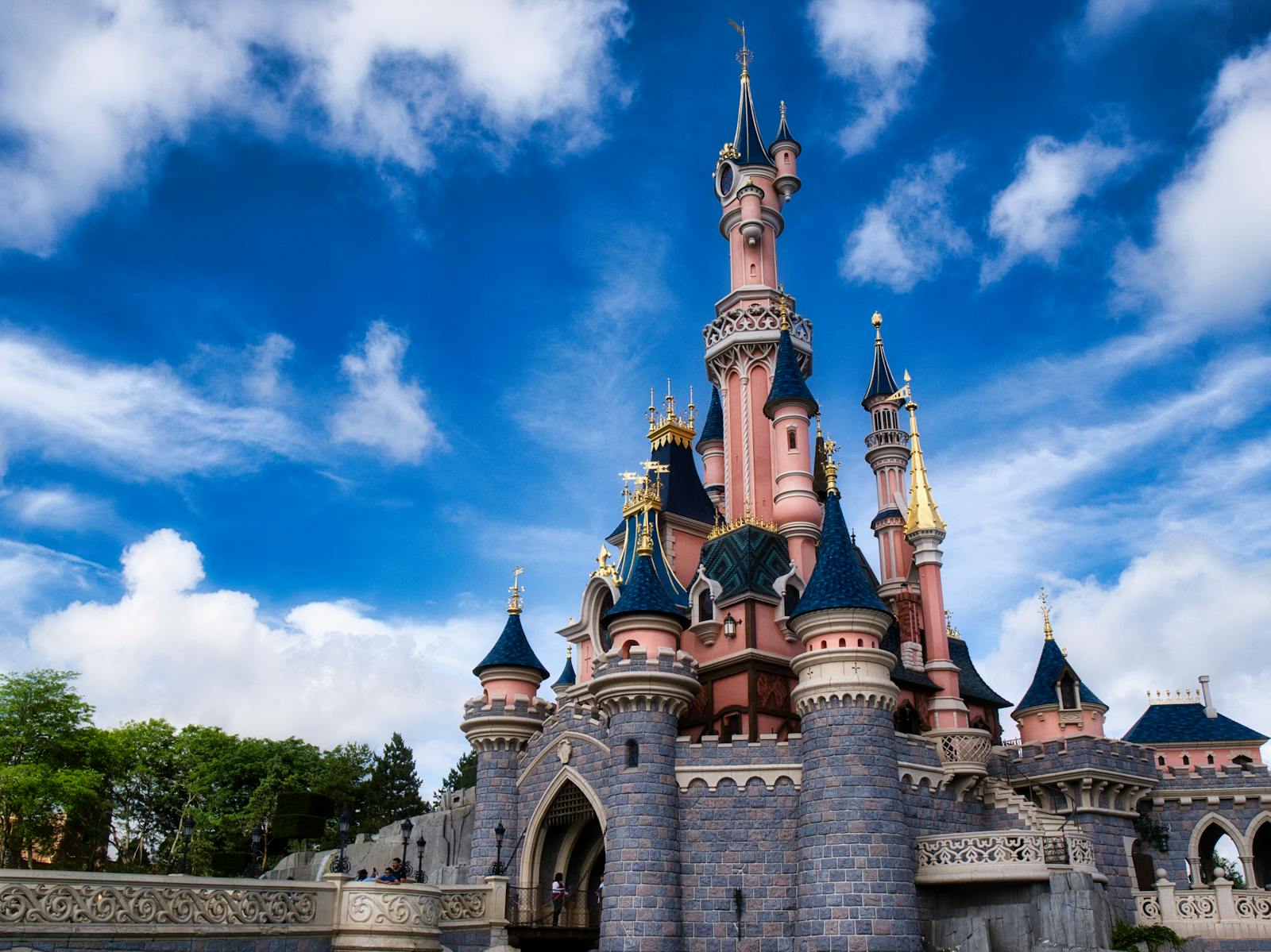 Magical view of the iconic Disneyland Paris castle with a vibrant blue sky.
