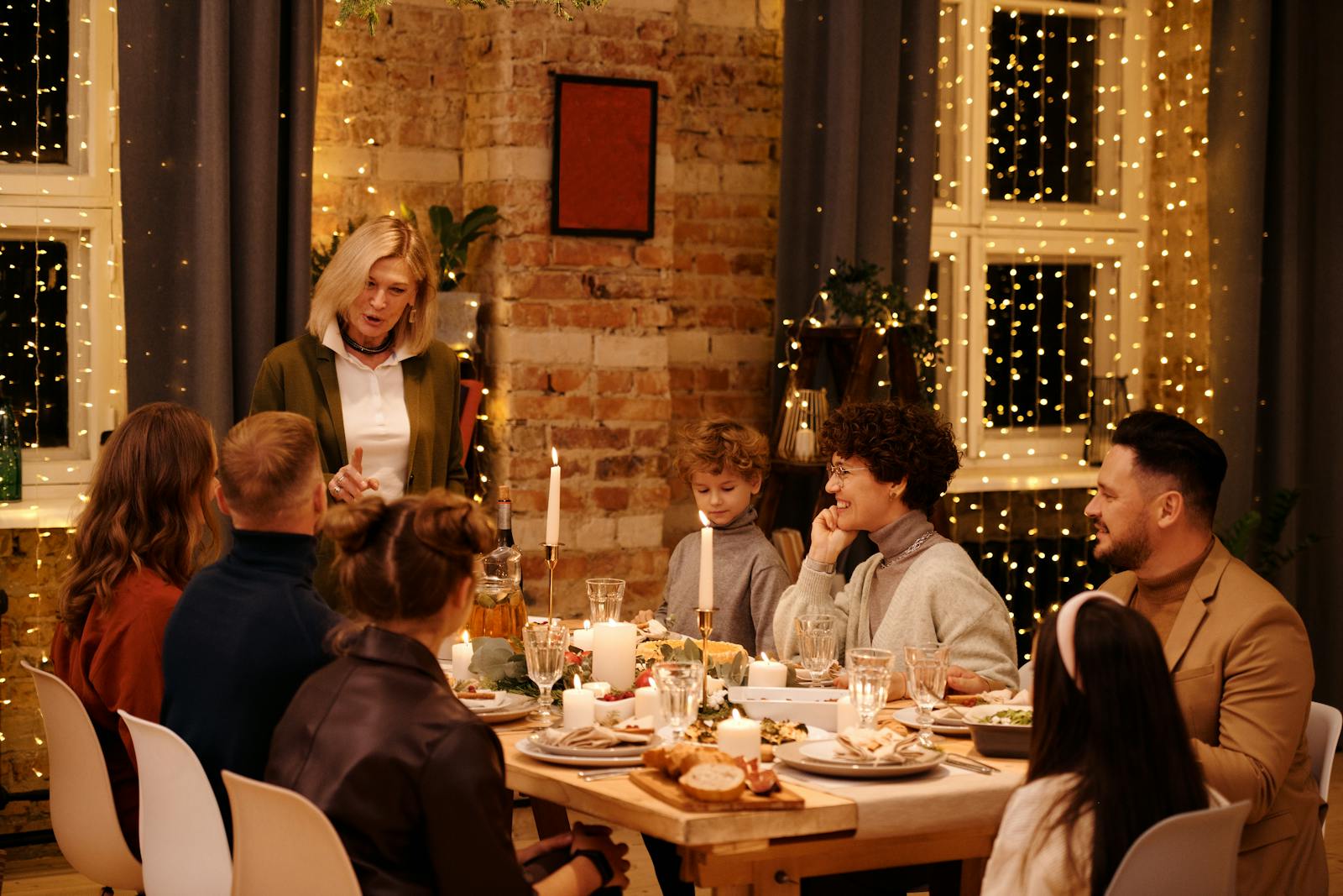 A joyful family celebrating Christmas dinner with festive decor and twinkling lights.