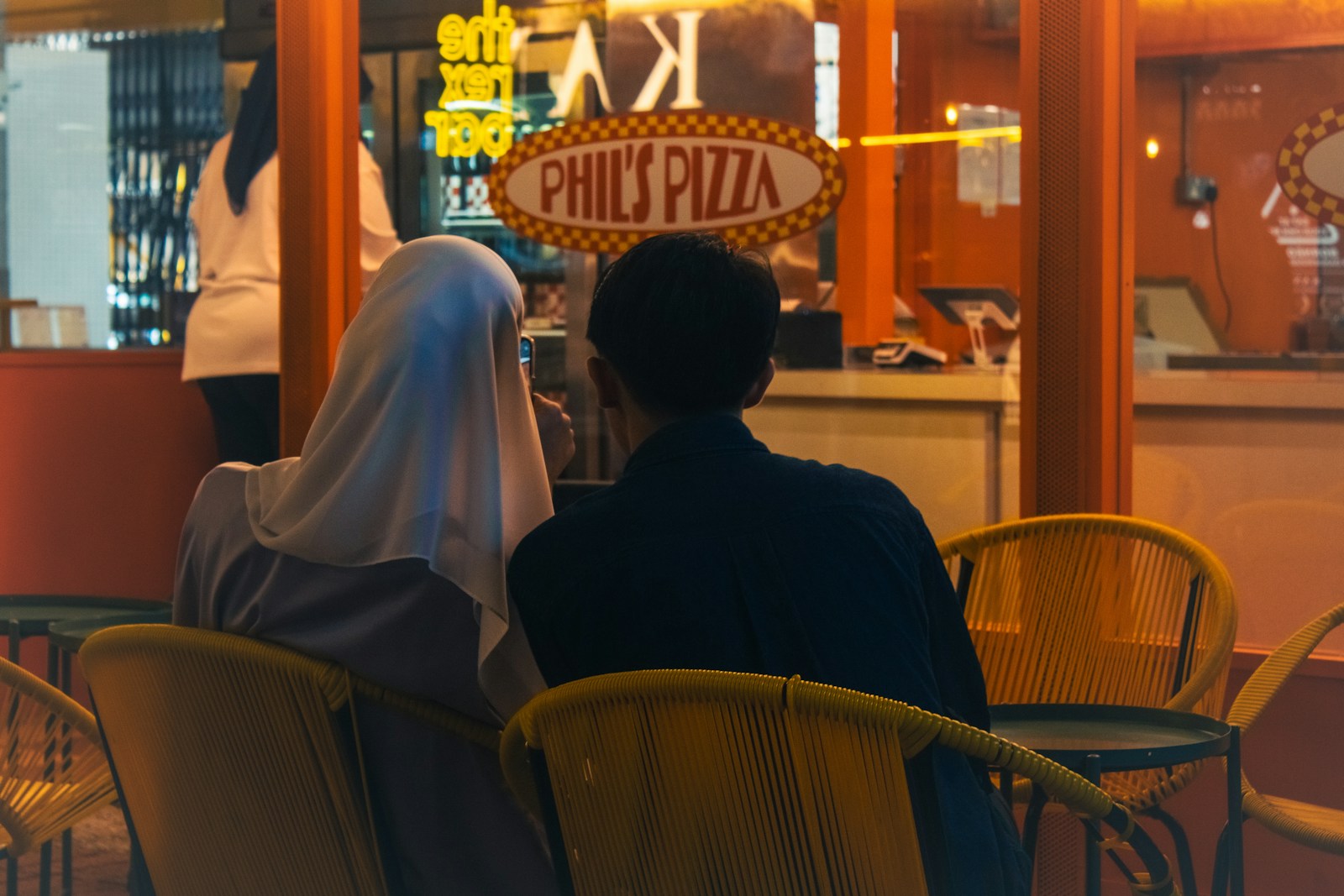Two people sitting at a table in a restaurant