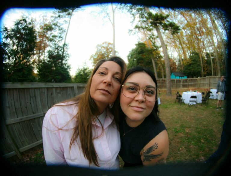 Two women pose for a selfie outdoors