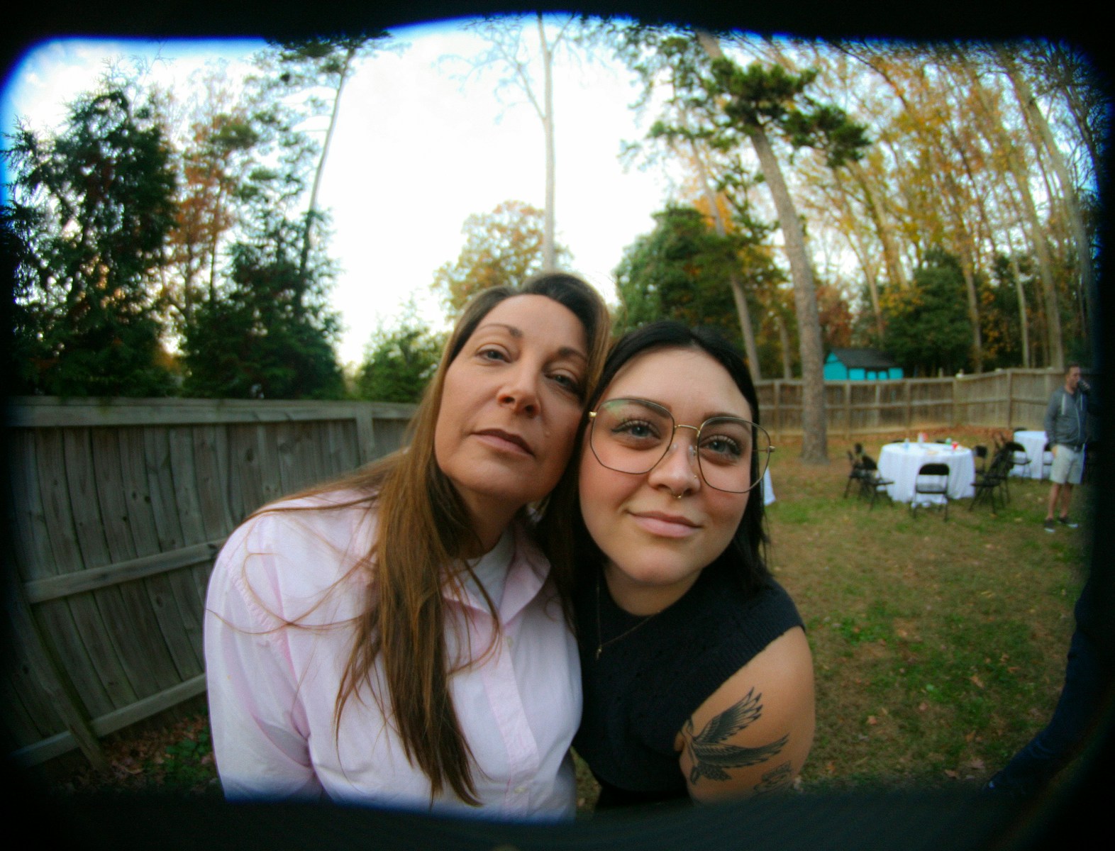 Two women pose for a selfie outdoors