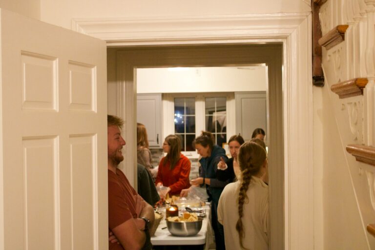 People gathered in a kitchen during a party.