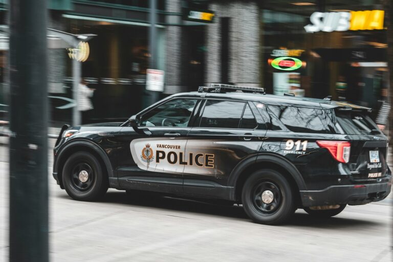 a police car driving down a city street