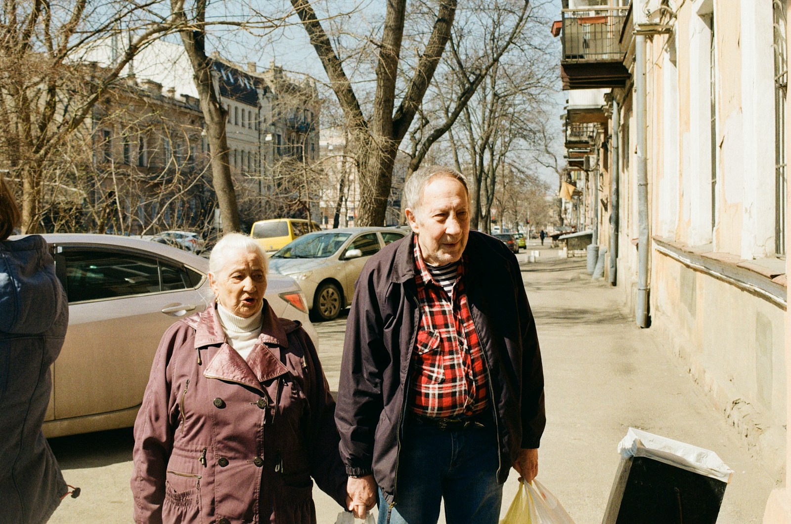 a group of people standing on a sidewalk