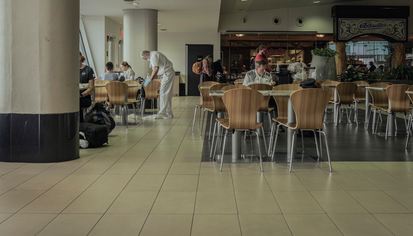 a group of people sitting at tables in a restaurant
