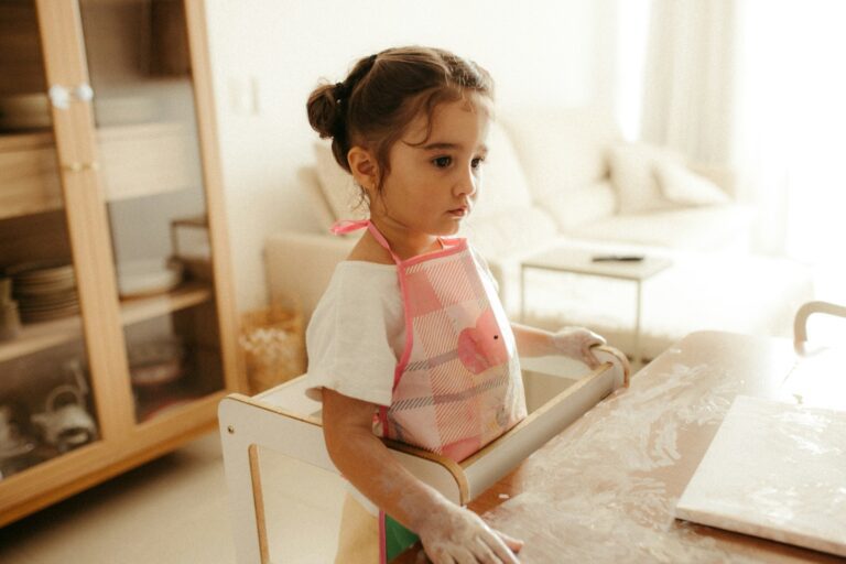 Young girl with rolling pin and flour