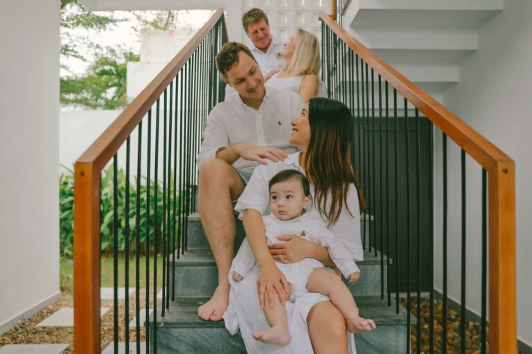 Family posing on stairs in white outfits