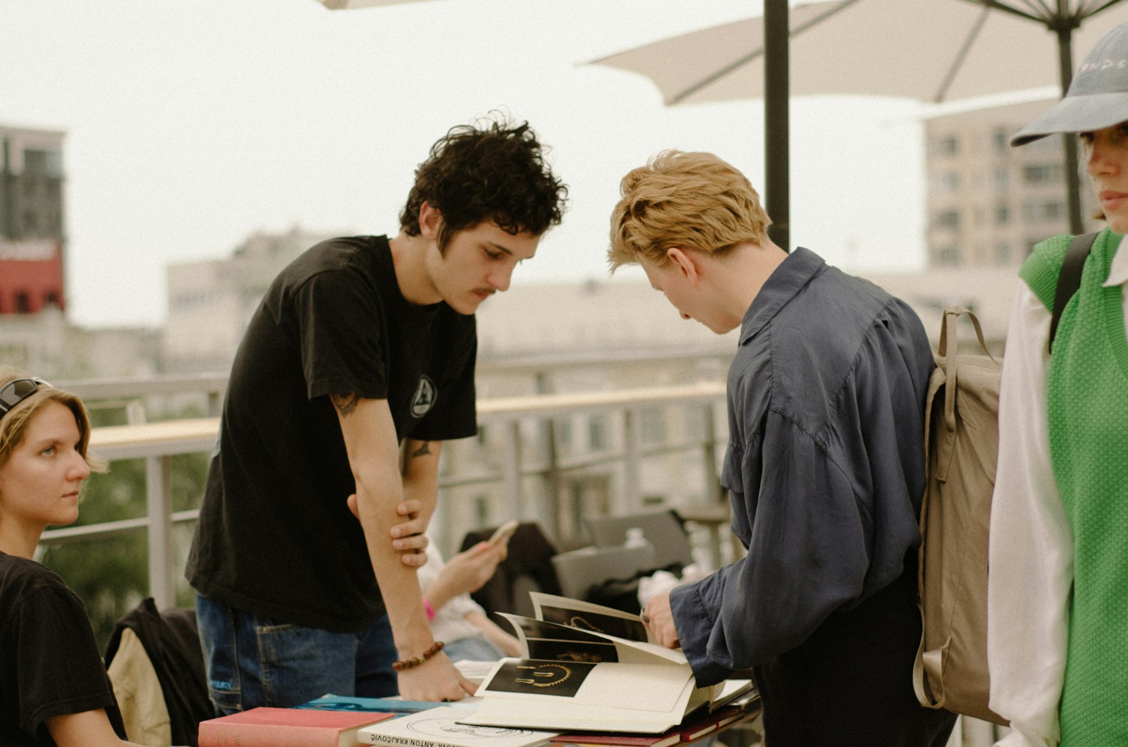 a group of young men standing around a table