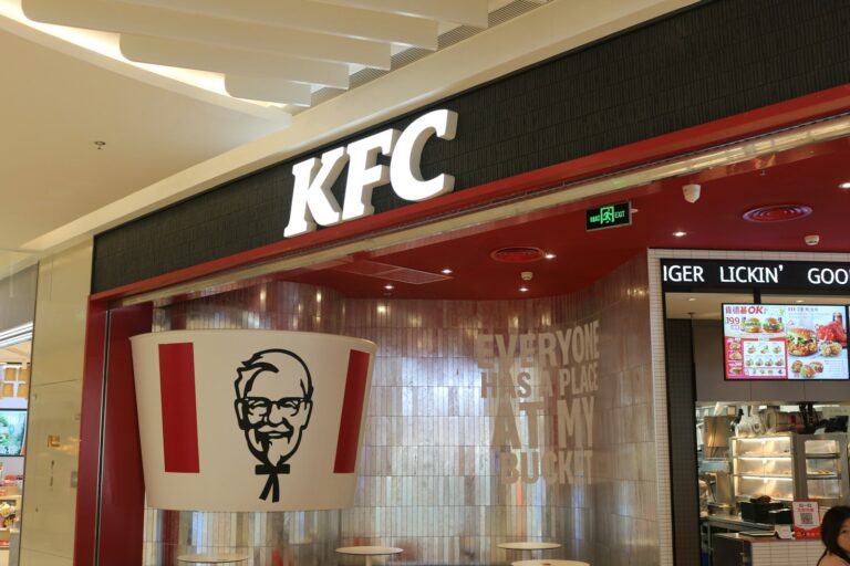 a kfc restaurant with a large sign above the entrance
