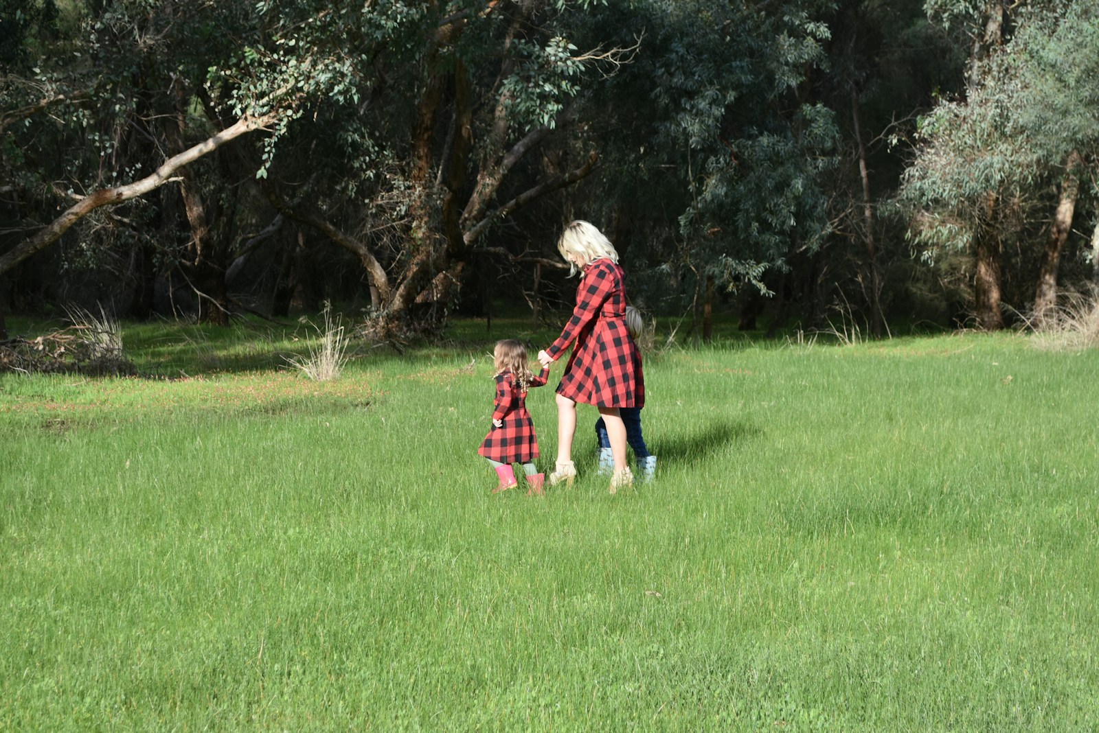 a woman and a child are playing in a field