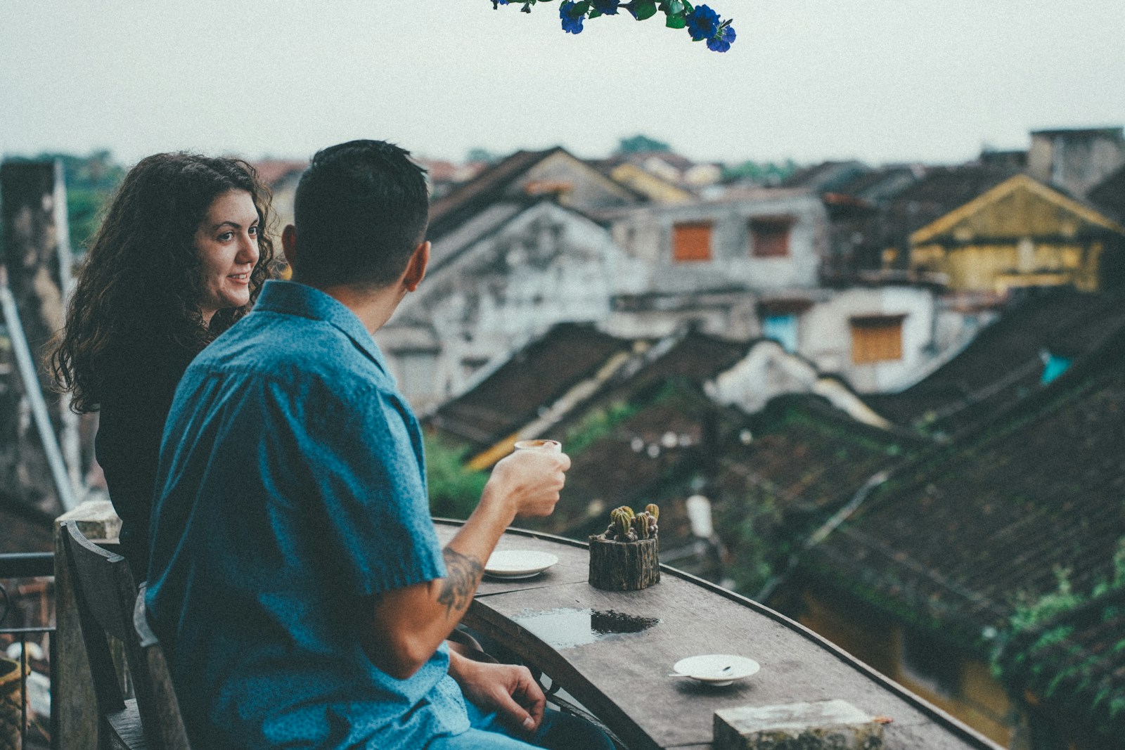 Couple enjoying coffee overlooking old town rooftops