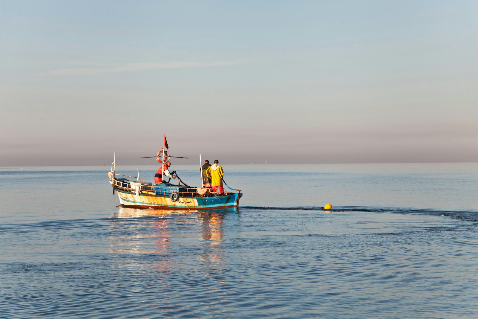 people on white and blue boat during daytime