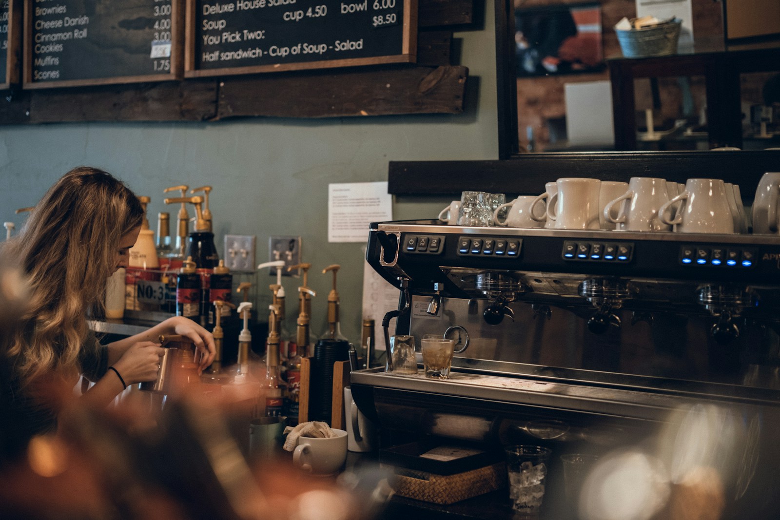 a woman sitting at a counter in a coffee shop