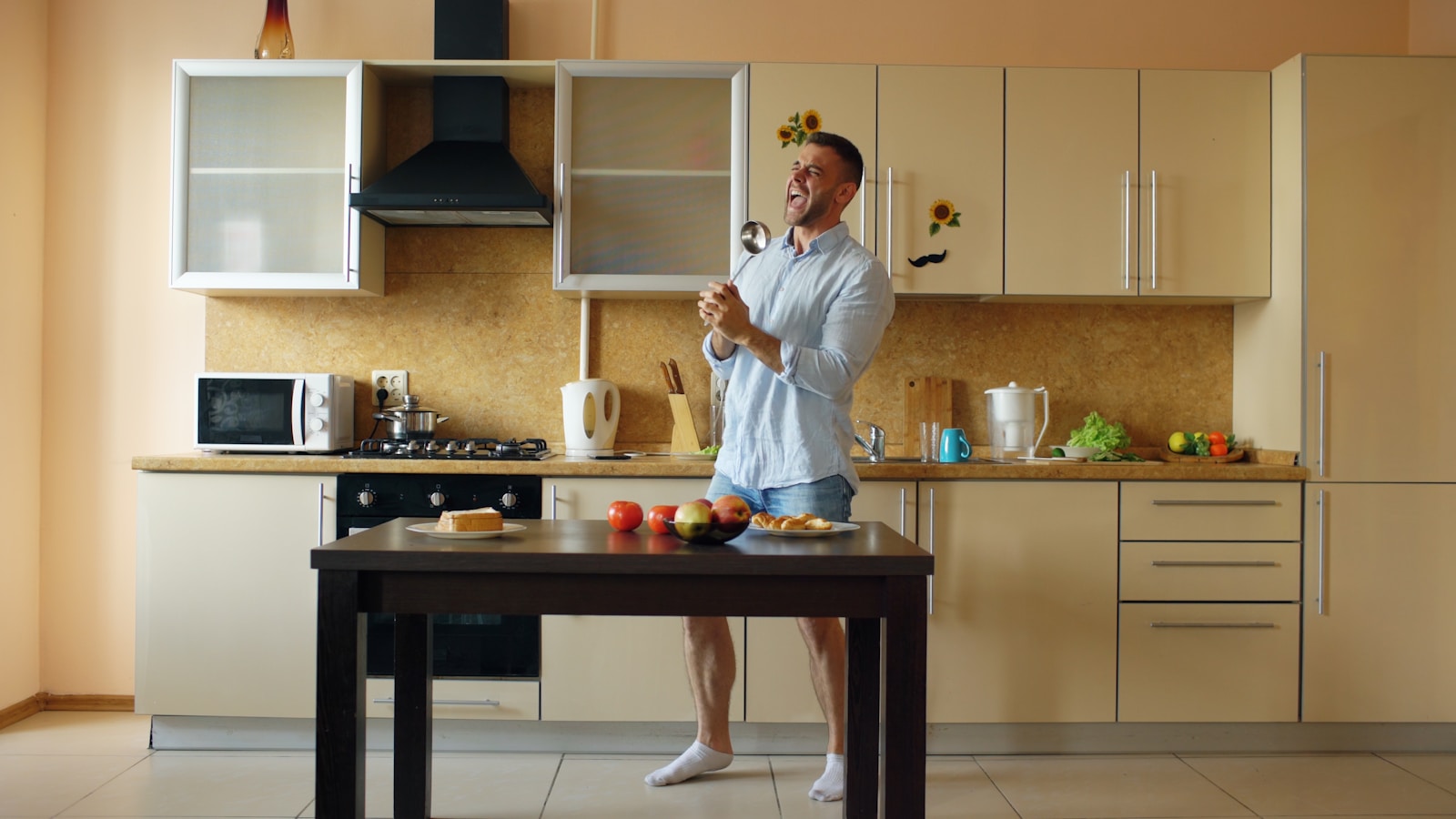 Man dancing in a modern kitchen