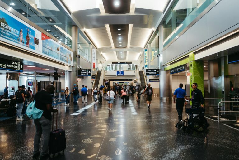 a group of people walking through an airport