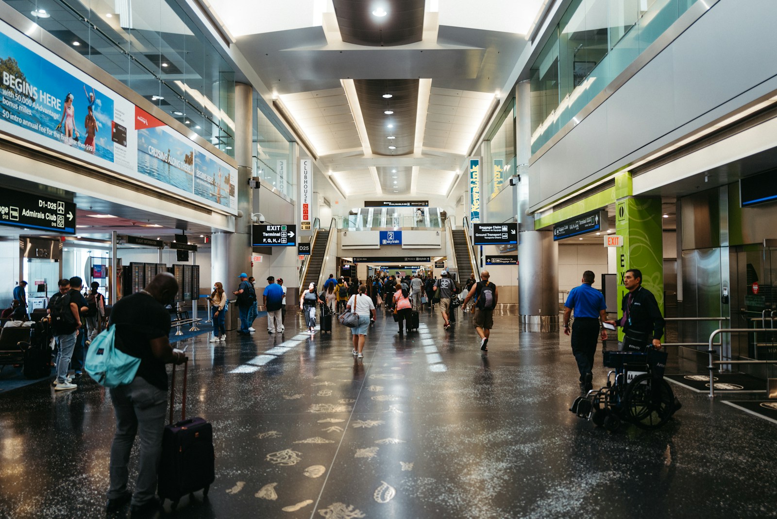 a group of people walking through an airport