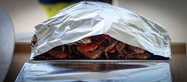 Cooked crawfish covered with aluminum foil.