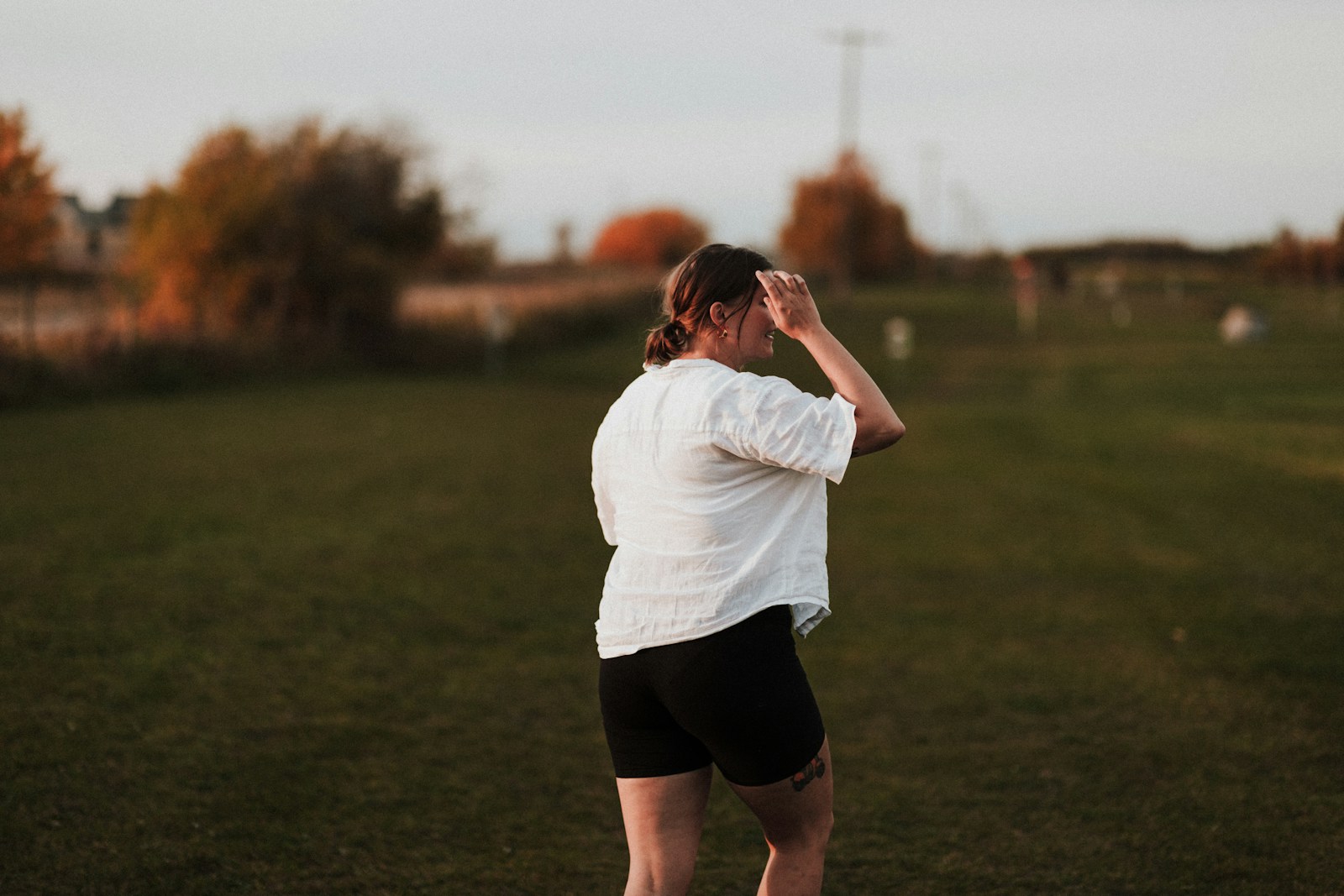 a person standing in a field with a frisbee