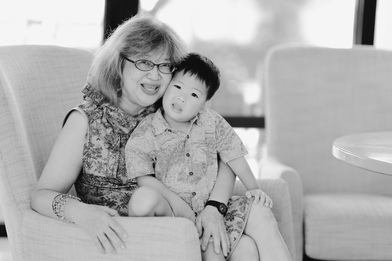 Woman and child sitting together in chairs.