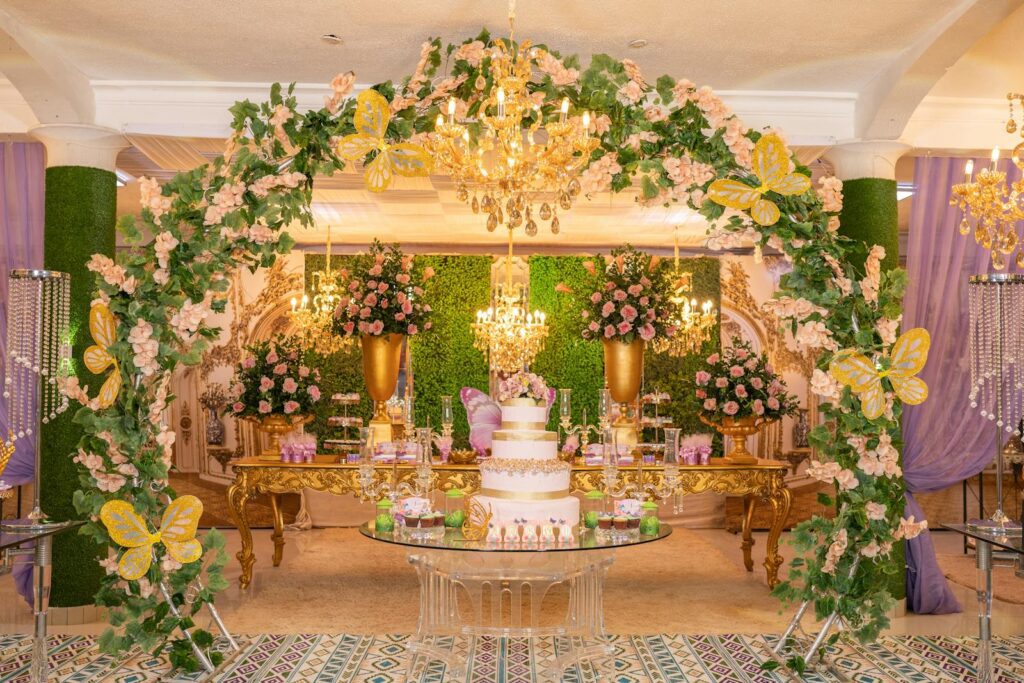Sophisticated quinceañera celebration featuring floral arches and chandeliers.