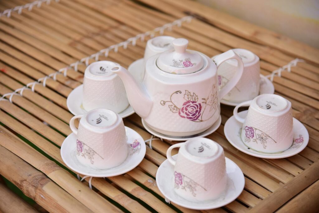 A beautifully designed floral tea set displayed on a bamboo table, perfect for a serene tea time.