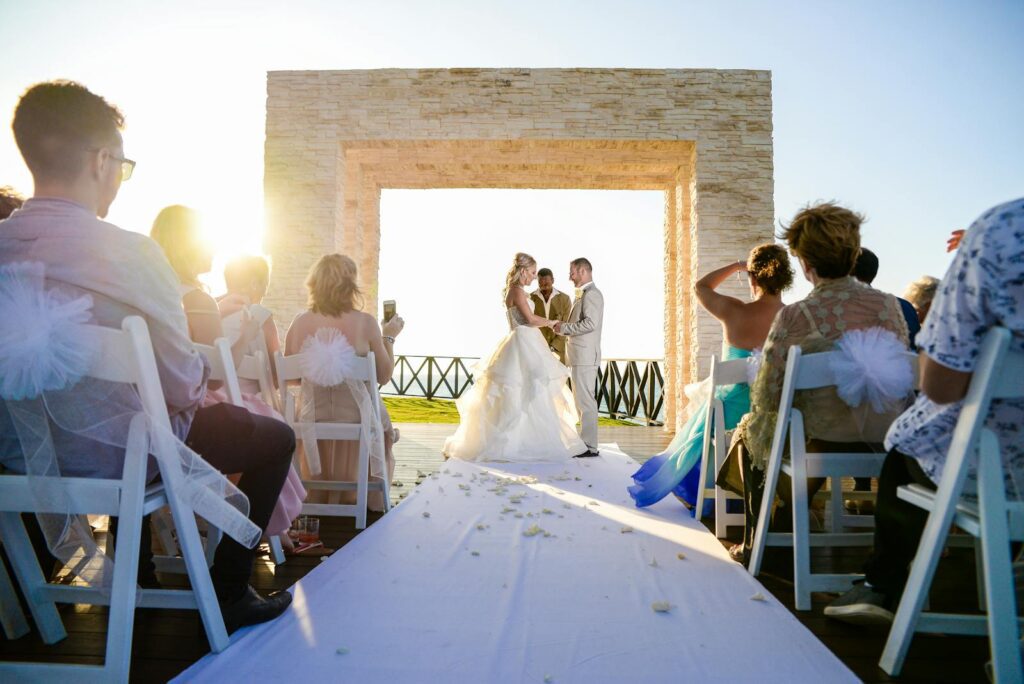 Wedding ceremony at a stunning outdoor beach venue, capturing love and togetherness at sunset.