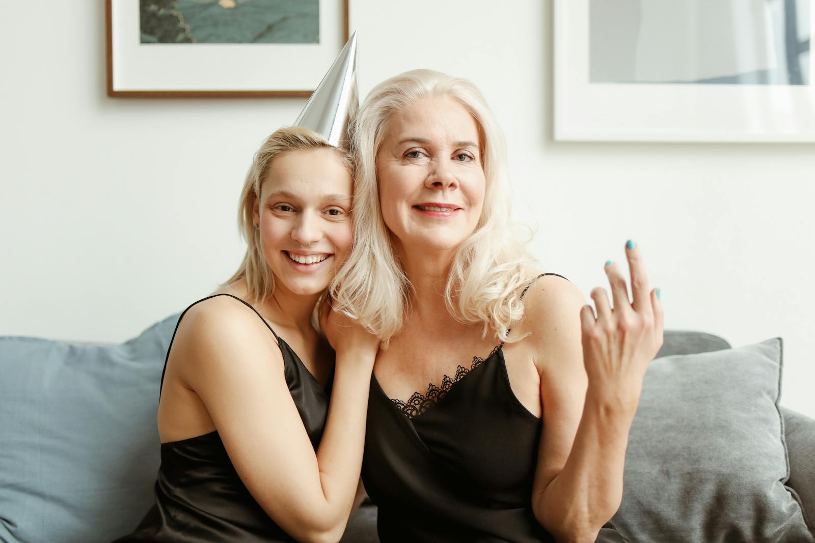 A joyful mother and daughter celebrating together indoors, showcasing love and happiness.