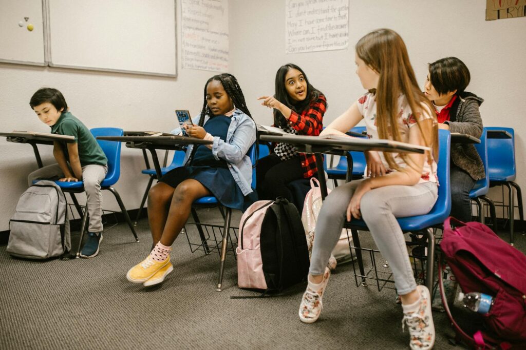 Group of diverse students interacting in a classroom, discussing topics.
