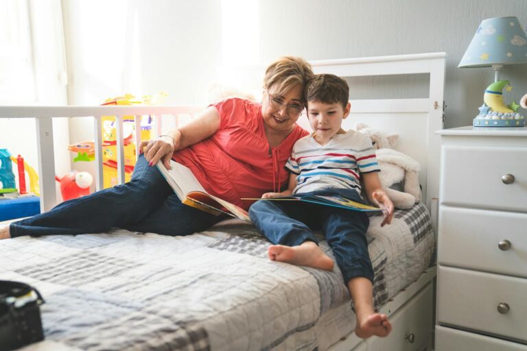 Heartwarming scene of a grandmother reading a bedtime story to her grandson in a cozy bedroom.
