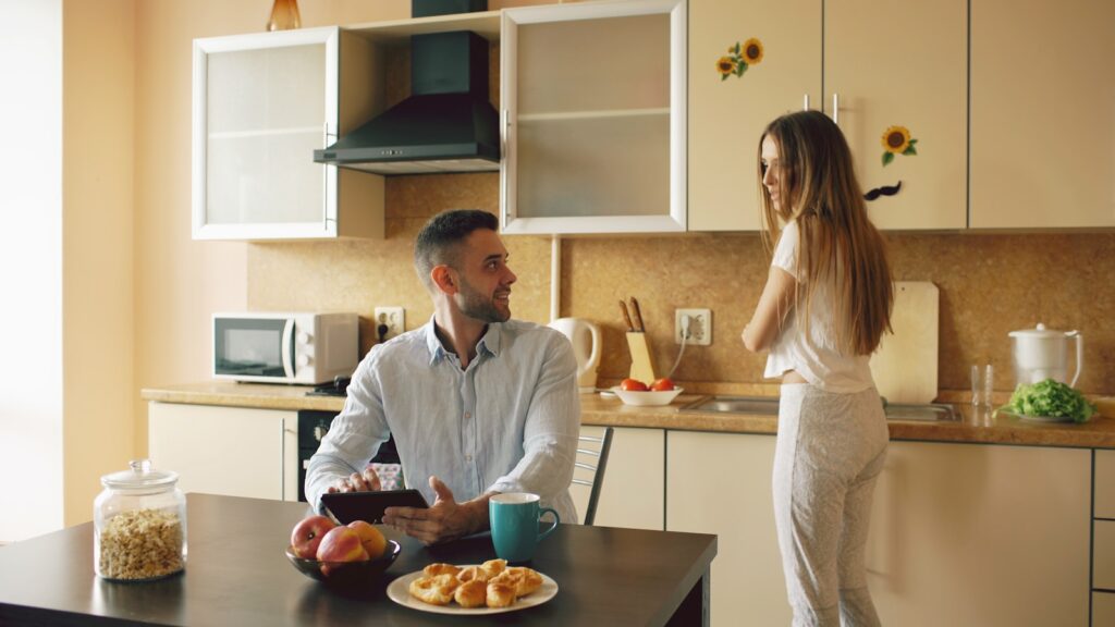 Couple talking in a modern kitchen during breakfast
