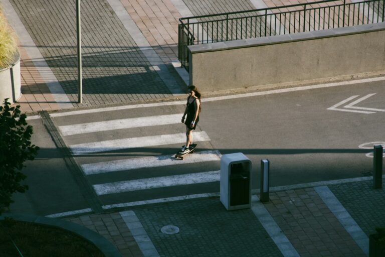Person skateboarding across a crosswalk