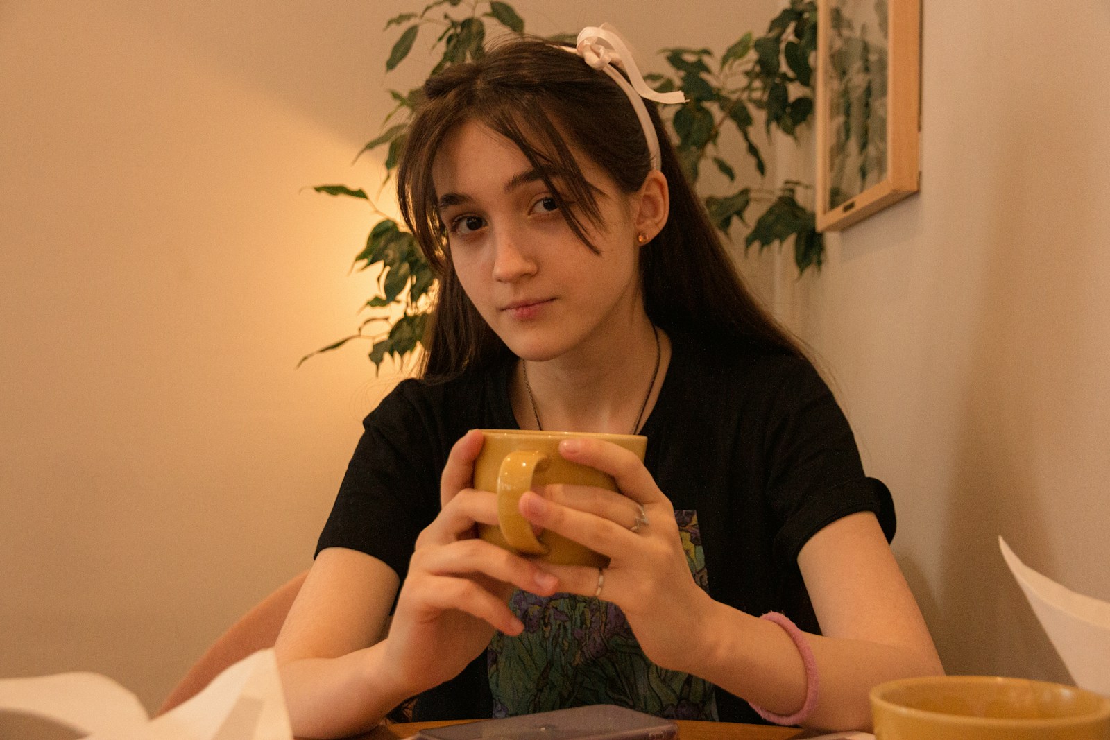 woman in black shirt holding yellow plastic cup