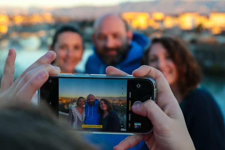 a group of people taking a picture with a cell phone