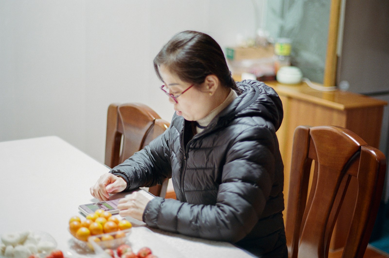 A woman sitting at a table with a plate of food