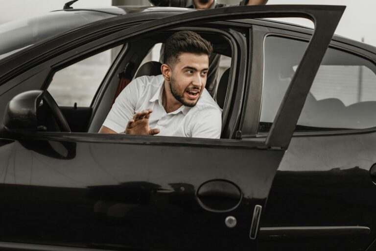 a person sitting on the seat of a car