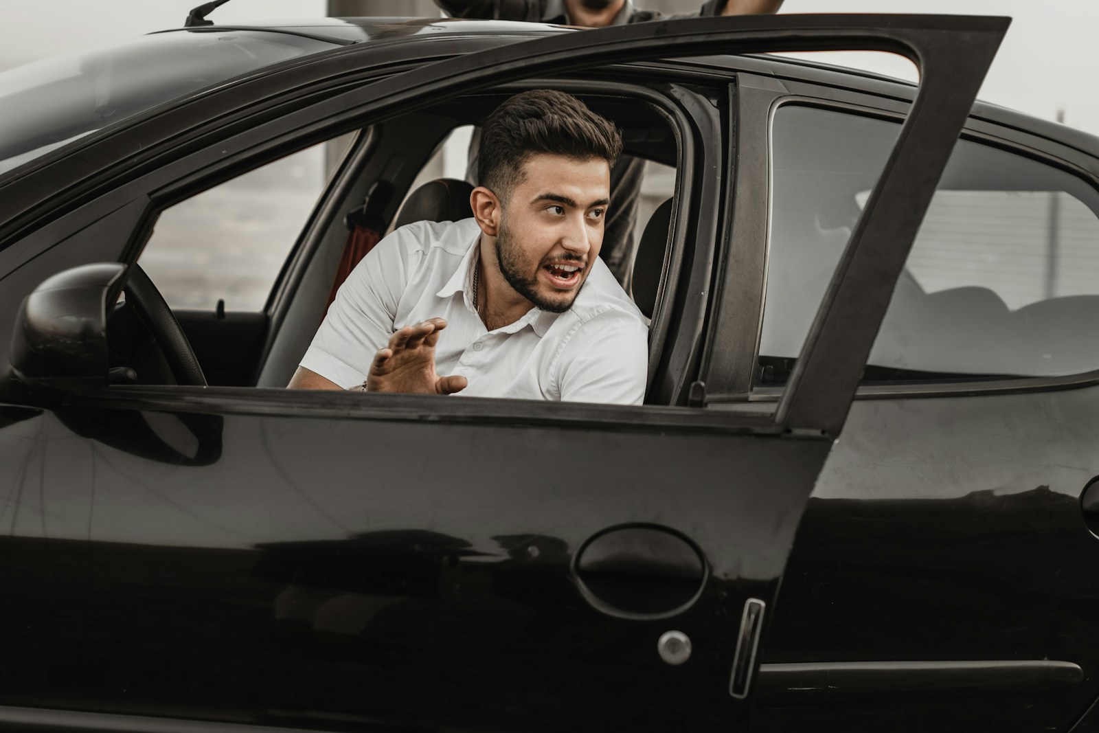 a person sitting on the seat of a car