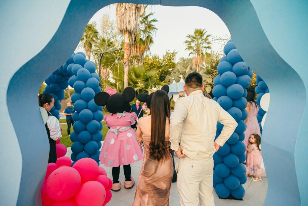 Minnie mouse greets guests at a party entrance