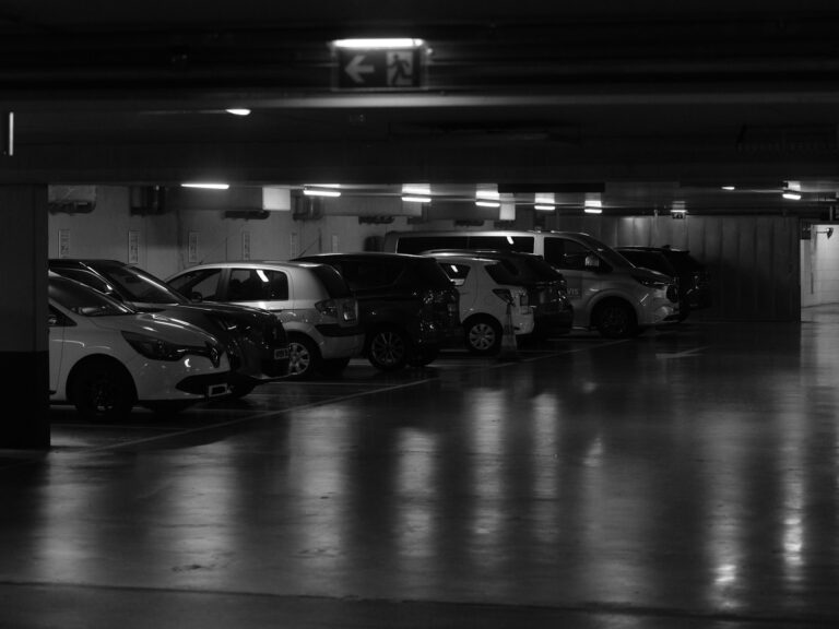 Cars parked in a dimly lit underground garage.